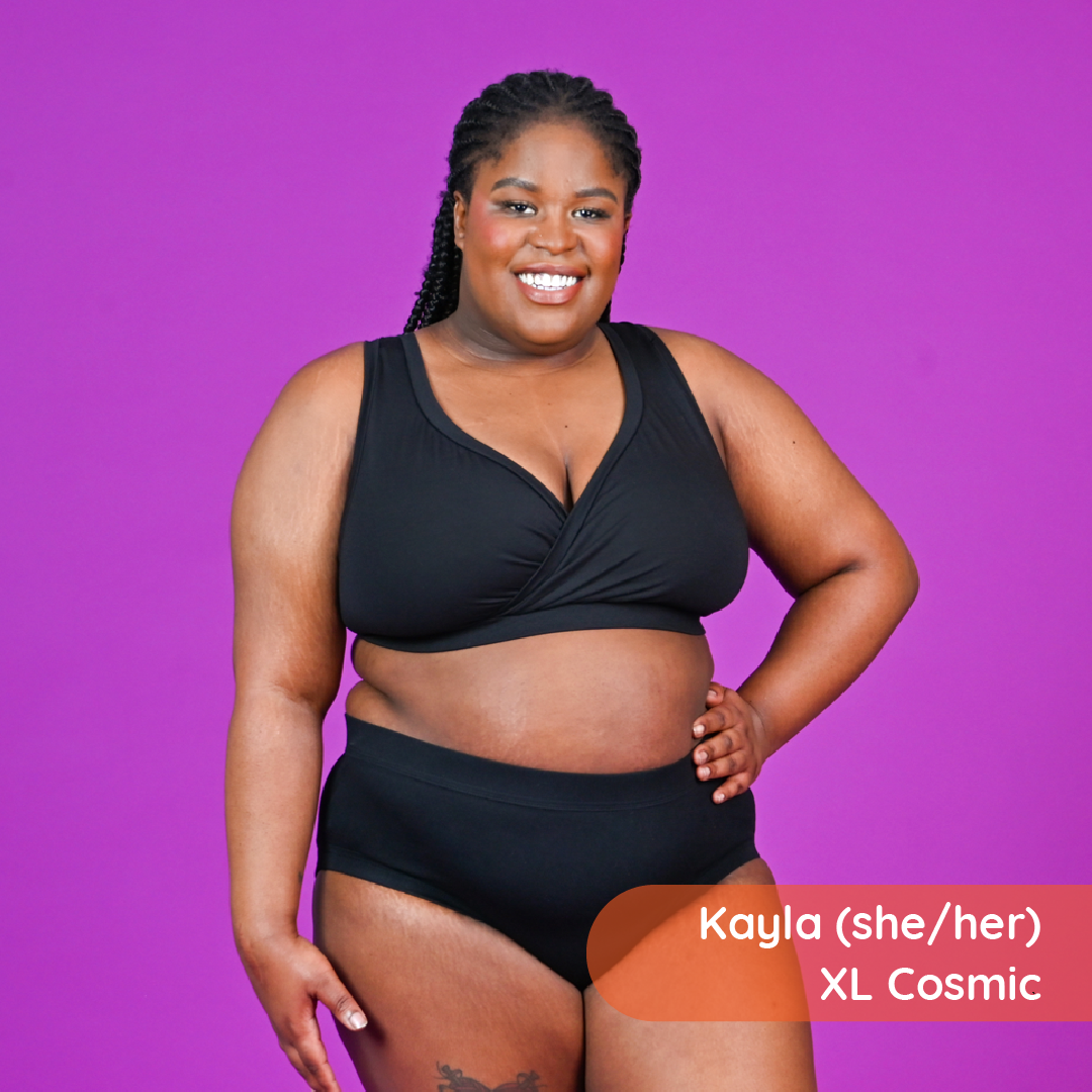Kayla is wearing a supportive black cotton bra and briefs