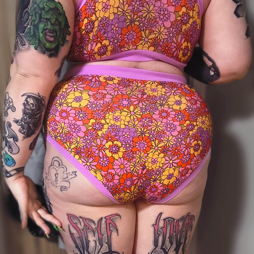 Chanelle has her back to camera wearing high rise cotton briefs in the Flora design.