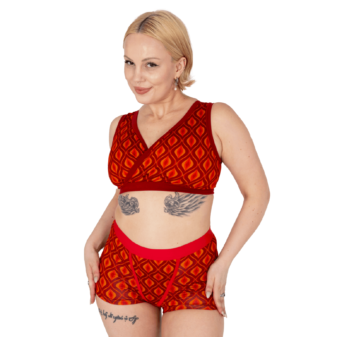 Model is wearing a pair of cotton boxers briefs in a retro Red Groovy pattern and matching bra