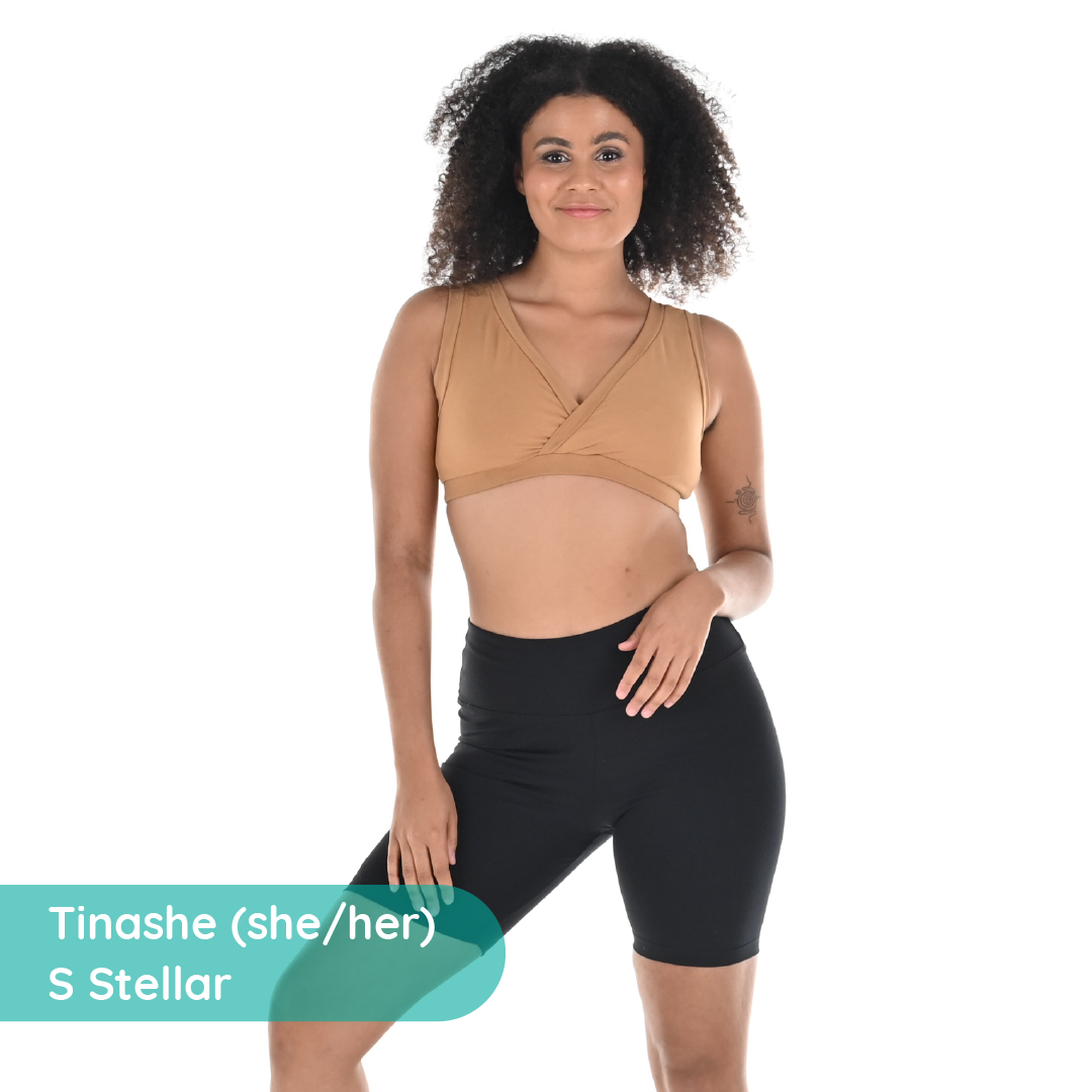 Tinashe is wearing a brown skin tone nude cotton bra and black cycling shorts