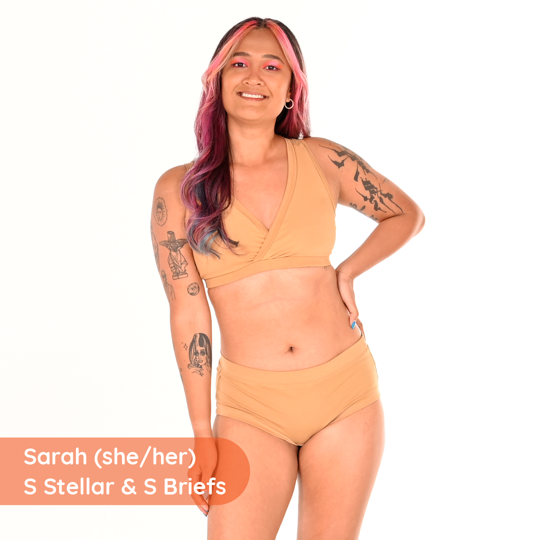 Sarah is wearing a nude bra and briefs