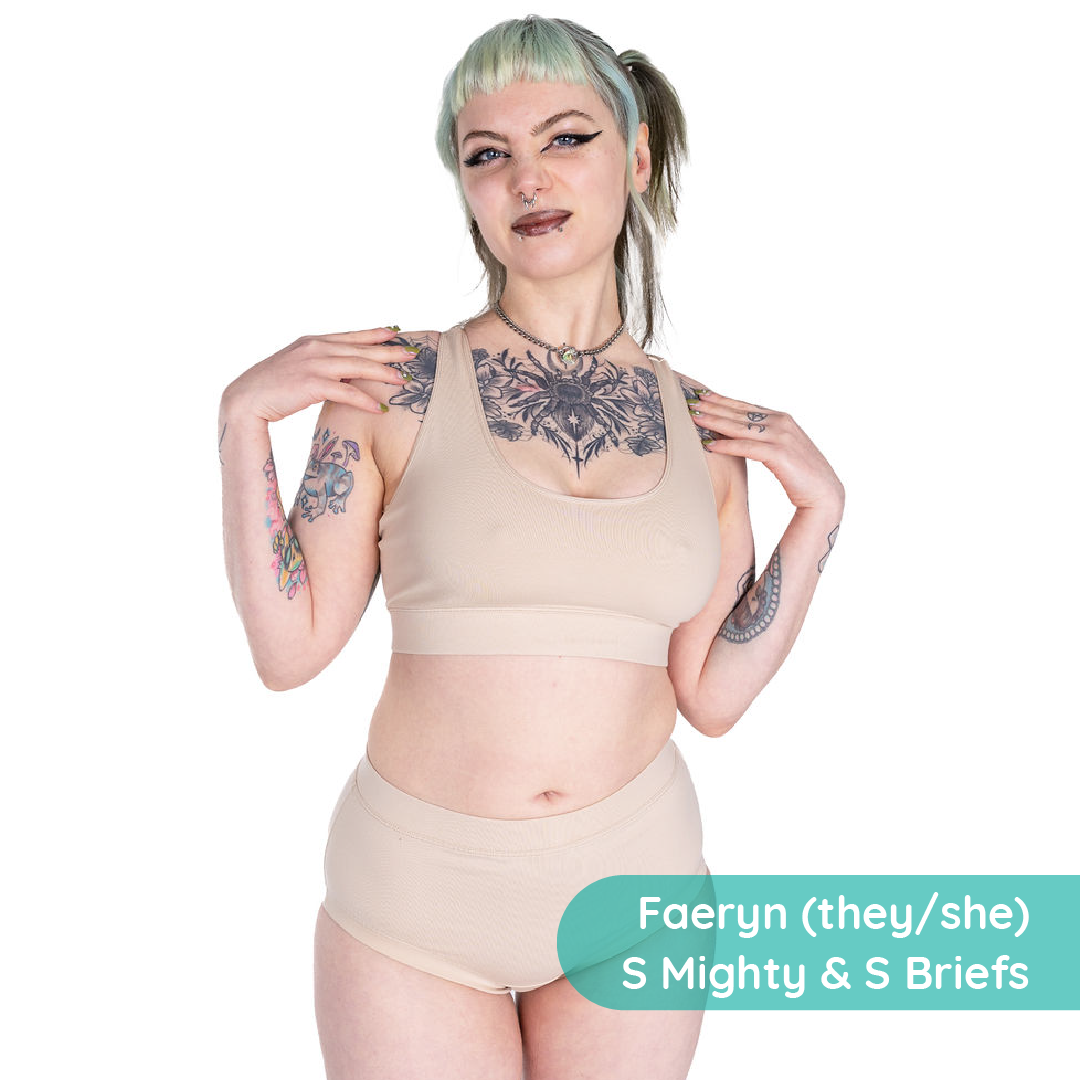 Person wearing beige lingerie with text 'Faeryn (they/she) S Mighty & S Briefs' on a white background