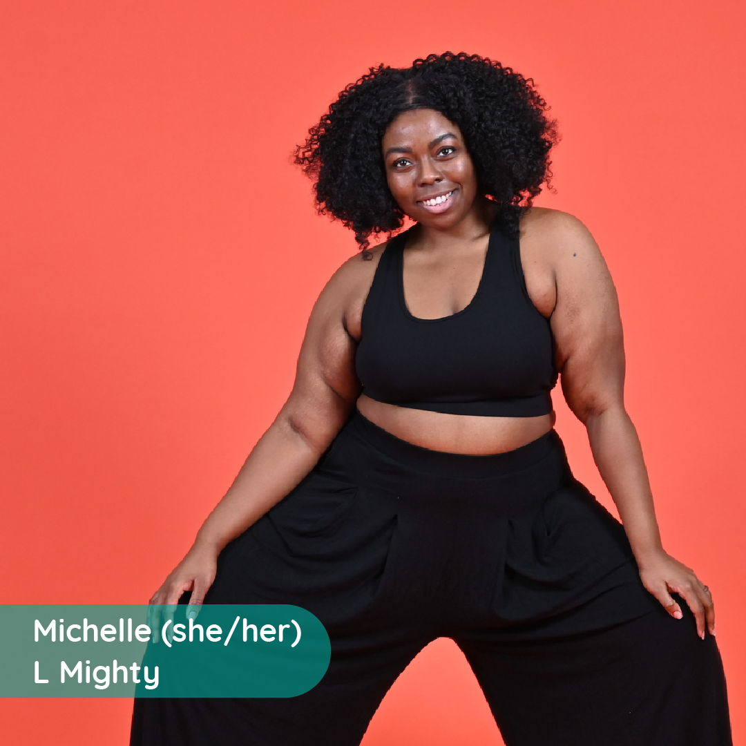 Michelle is wearing a black crop top and trousers