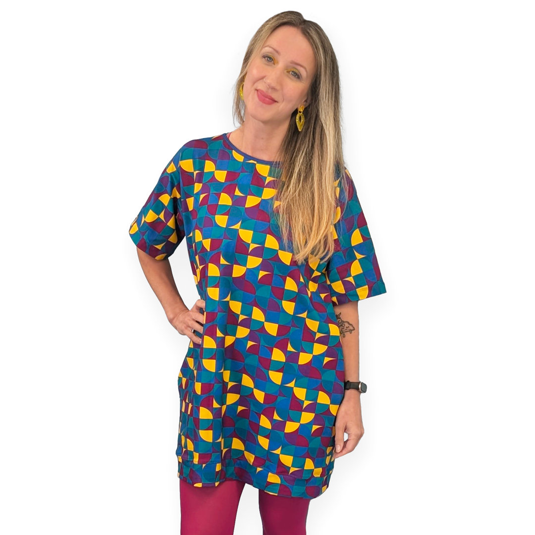 Ros is wearing a cotton tunic style dress in Eclipse fabric with dark pink tights.