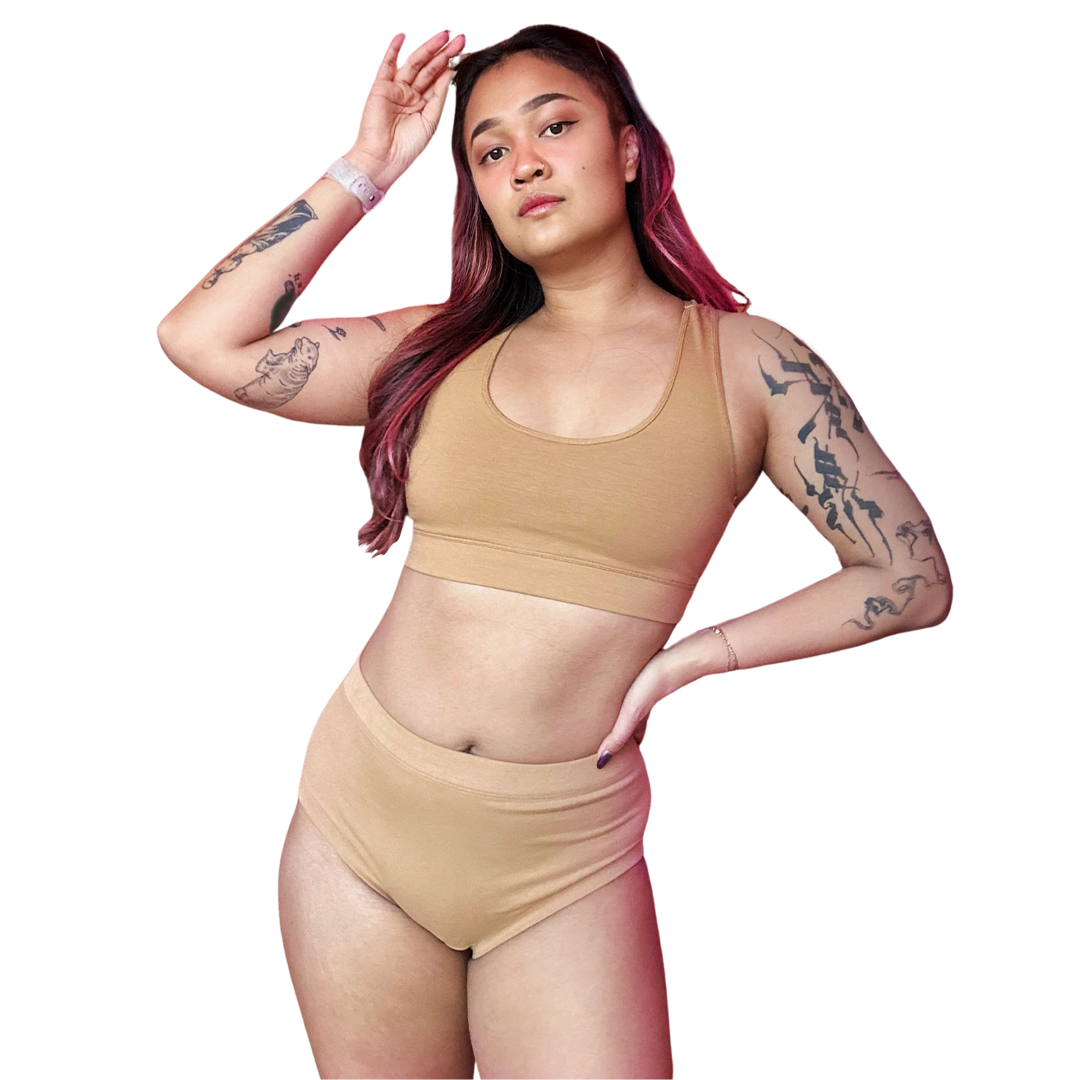 Sarah is wearing a  firmer fit nude skin tone cotton racerback bralette and briefs