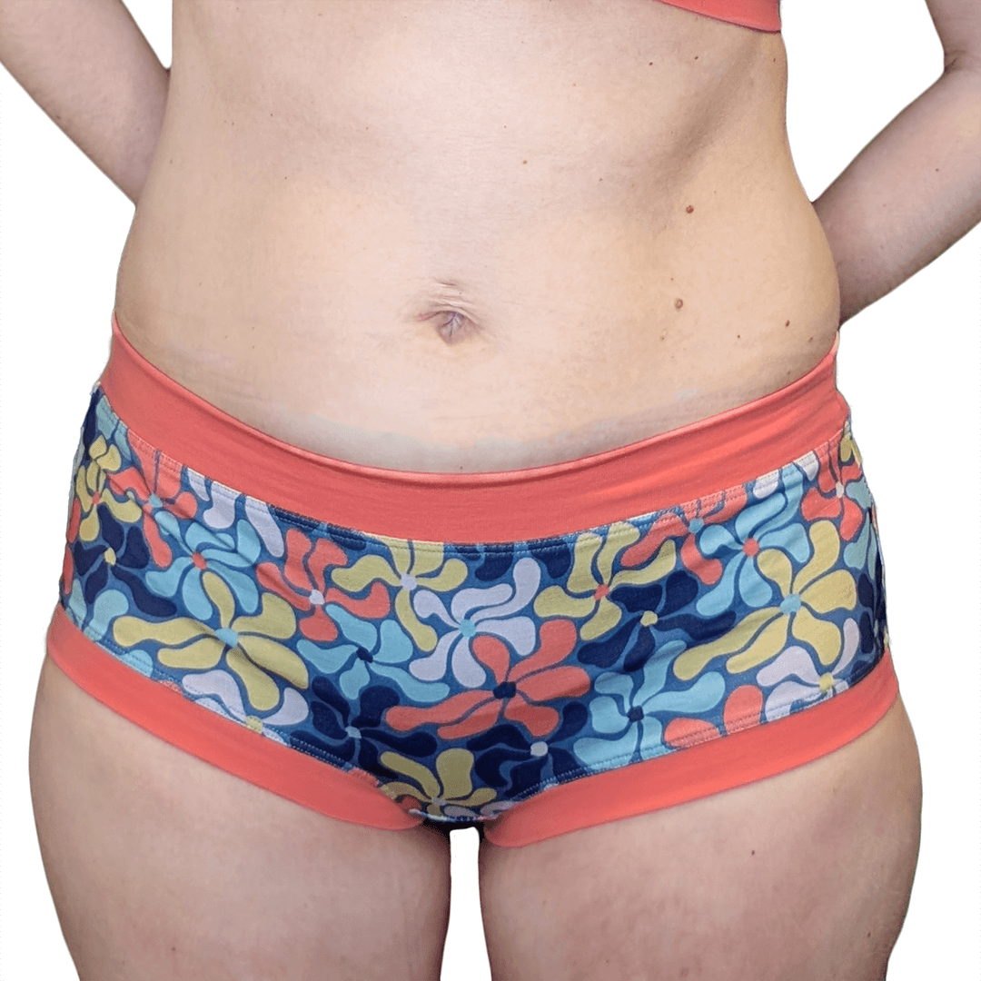 Cropped image of model wearing mid rise cotton briefs in Wavy Flowers pastel design