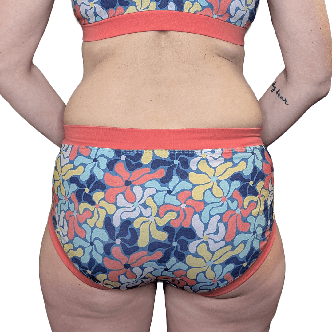 Back cropped view of model wearing mid rise cotton briefs in Wavy Flowers