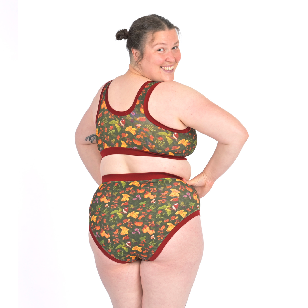 Back view of Katy in a pull on non wired bra with a woodland design