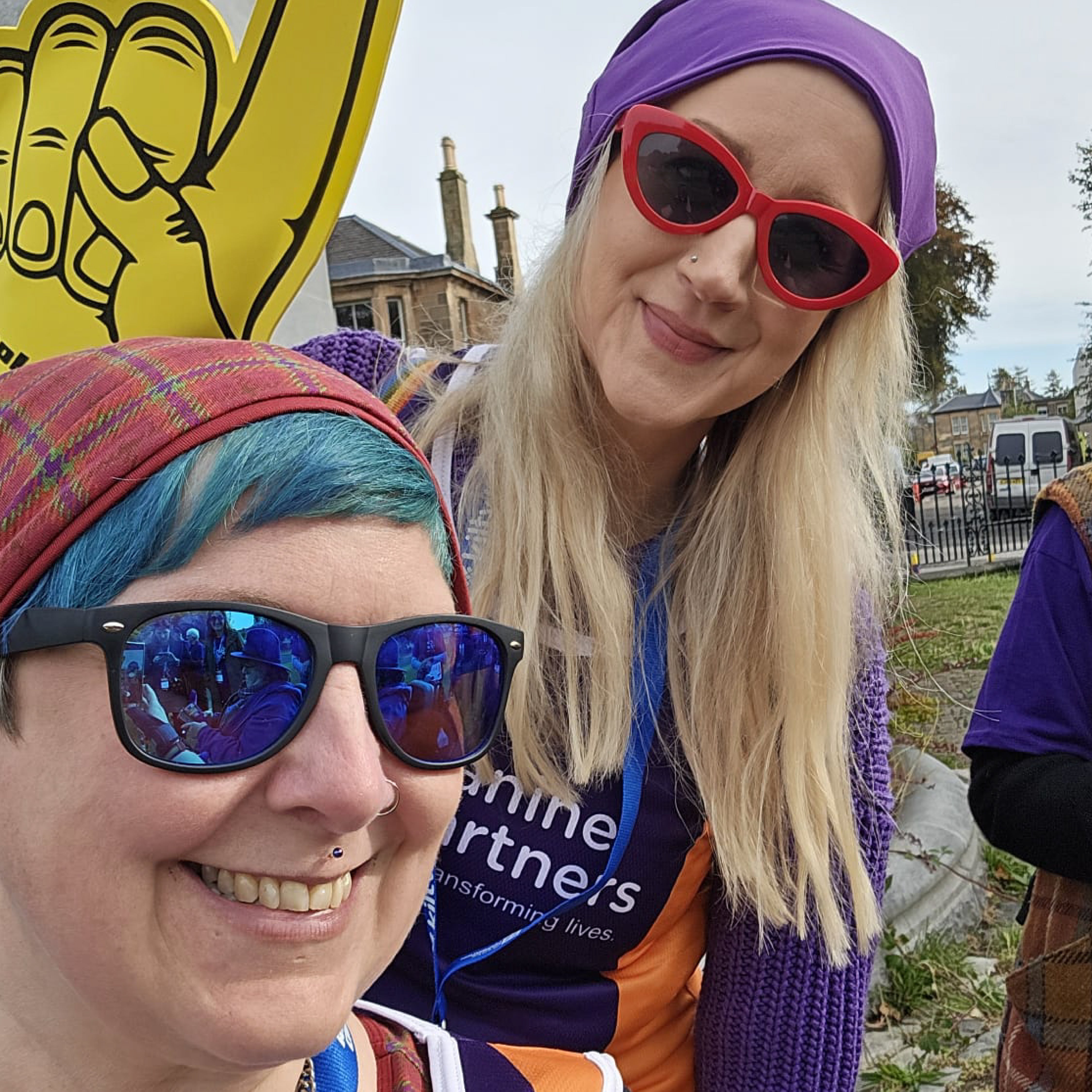 Kirsty and ros are wearing a tartan and Iris beanie hat and shades