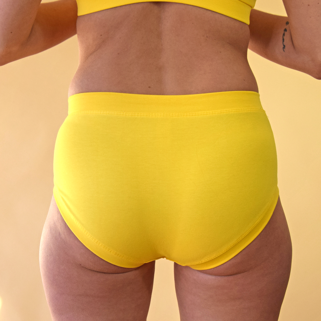 crop of model wearing yellow marigold mid rise briefs