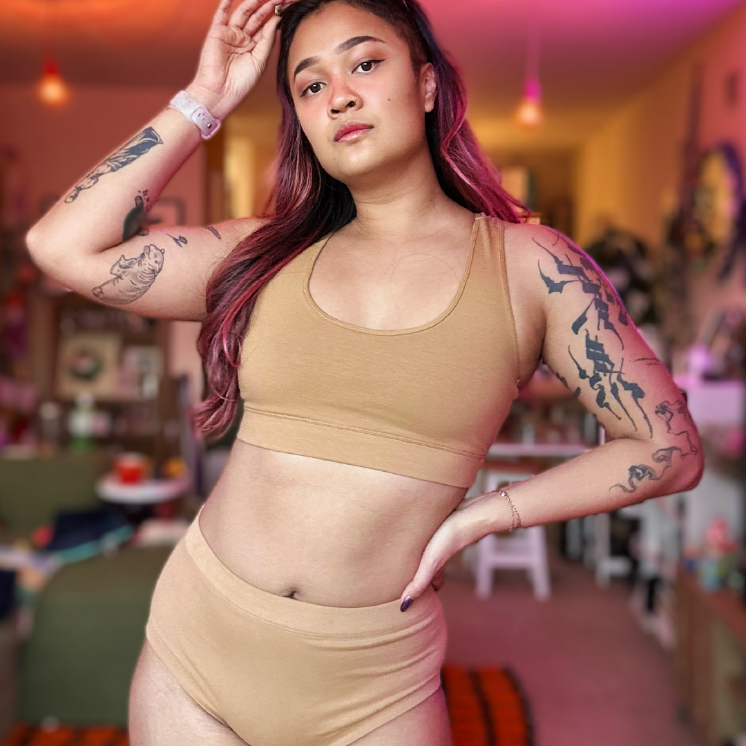 Sarah is wearing a skin tone nude bralette and briefs