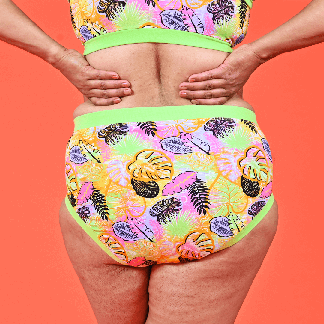 Cropped photo of back view of Anita wearing high rise Calypso briefs and bra