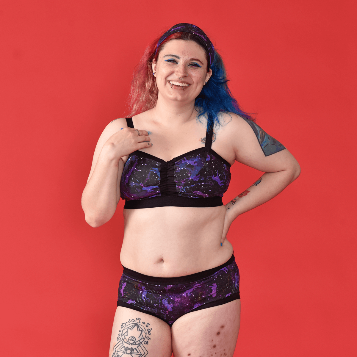 Autumn is wearing mid rise briefs and non wired bra in a unicorn galaxy pattern