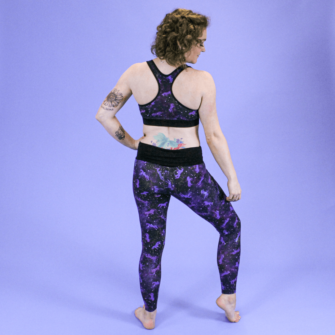 Back view of Jenni wearing full length universe leggings and racerback bralette