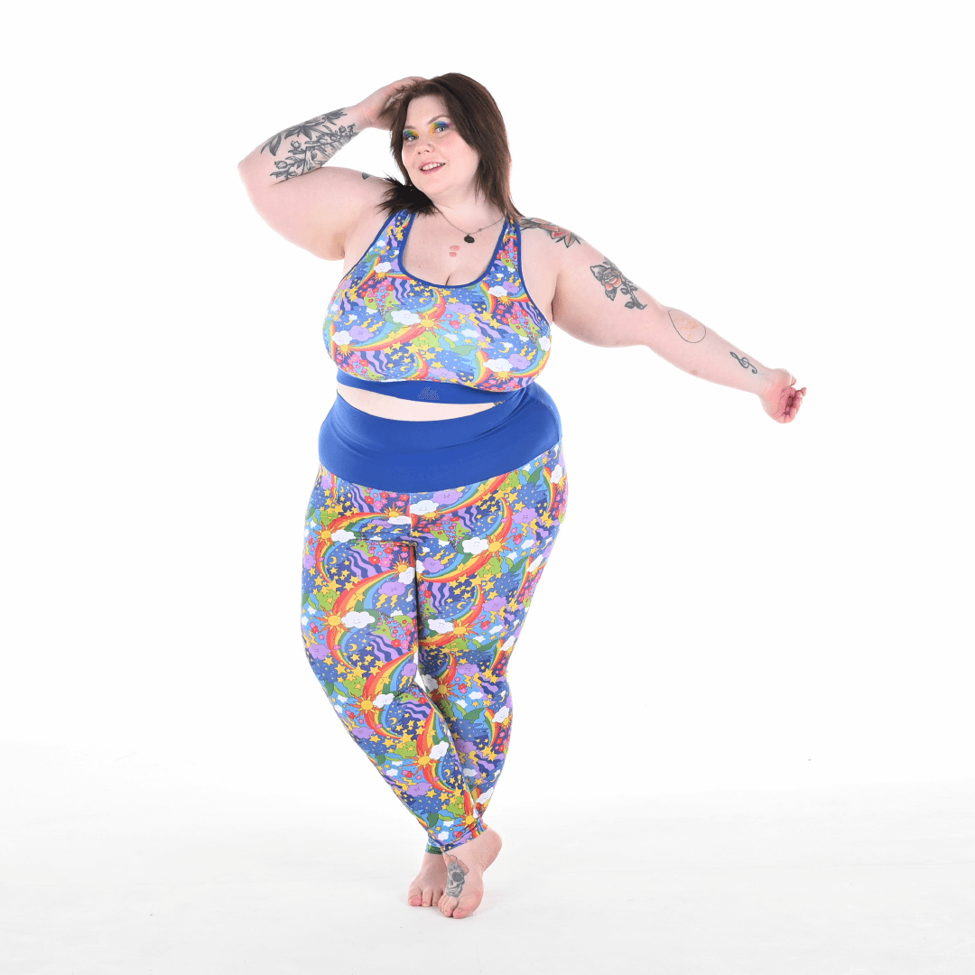 Molly is wearing a rainbow bralette and leggings